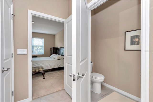 bathroom featuring tile patterned flooring and toilet