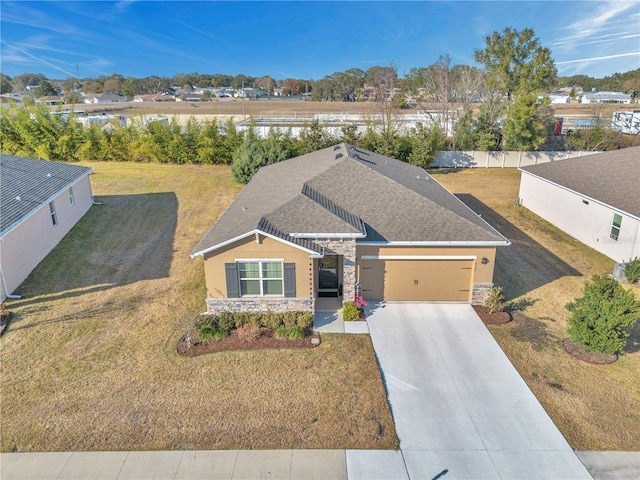 view of front of house featuring a garage and a front yard