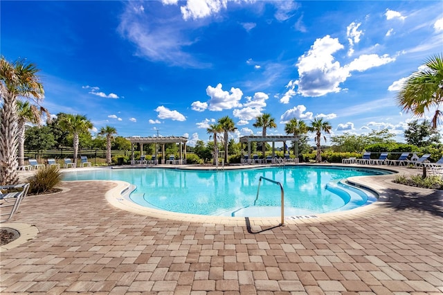 view of pool with a pergola and a patio area