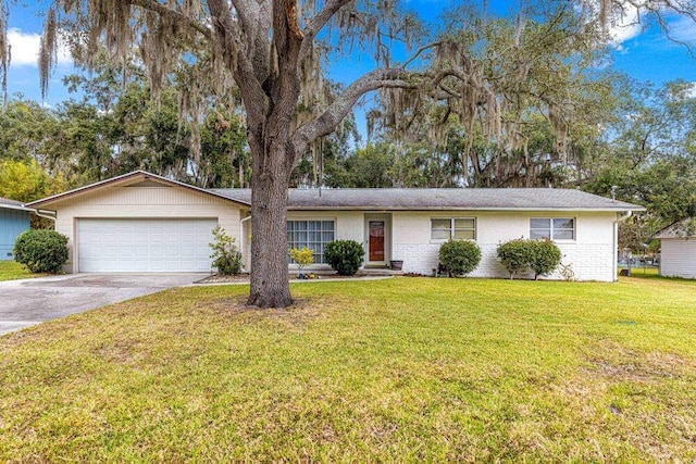 ranch-style house featuring a front lawn and a garage