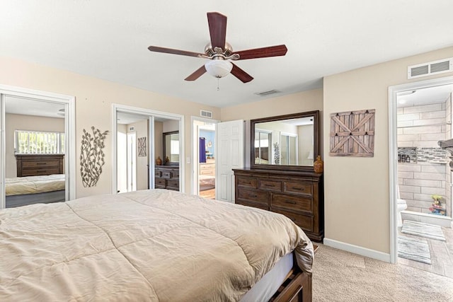 bedroom featuring ensuite bath, ceiling fan, and light colored carpet