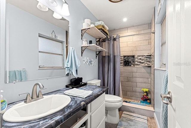 bathroom with vanity, curtained shower, and toilet