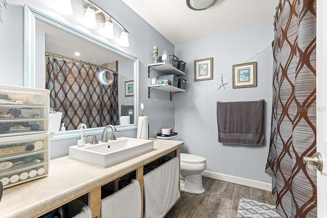 bathroom with hardwood / wood-style floors, vanity, and toilet