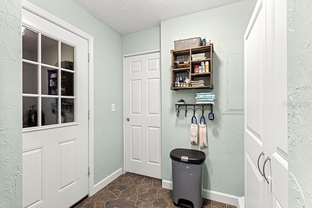 mudroom with a textured ceiling