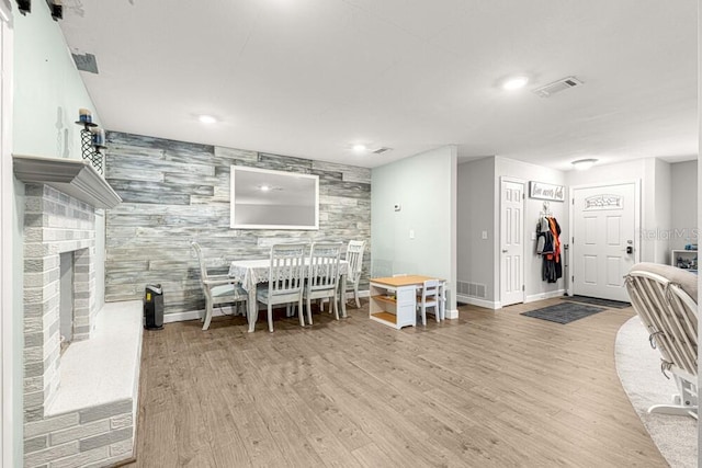 interior space with a brick fireplace and light wood-type flooring