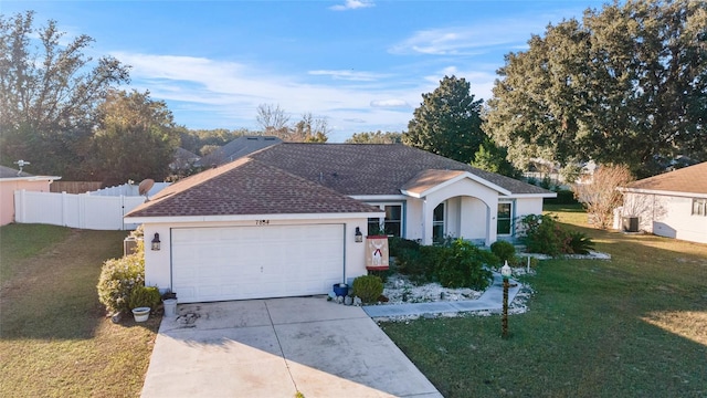 ranch-style house with a garage and a front lawn