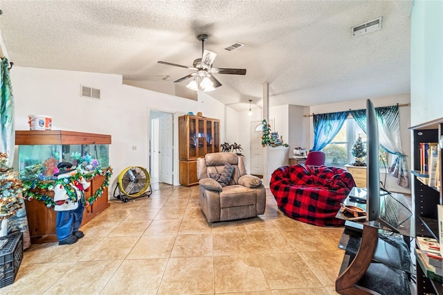 living room with a textured ceiling, ceiling fan, light tile patterned floors, and lofted ceiling