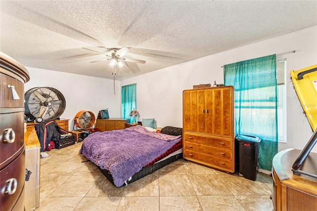 tiled bedroom with ceiling fan and a textured ceiling