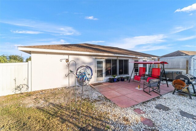 rear view of property featuring a patio area