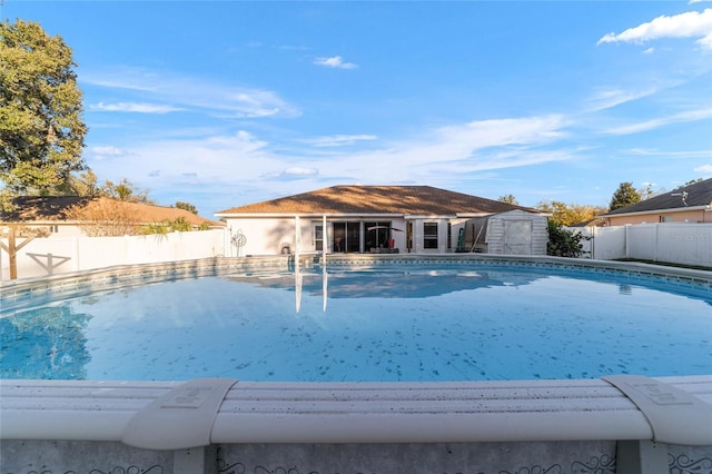 view of pool with a storage shed