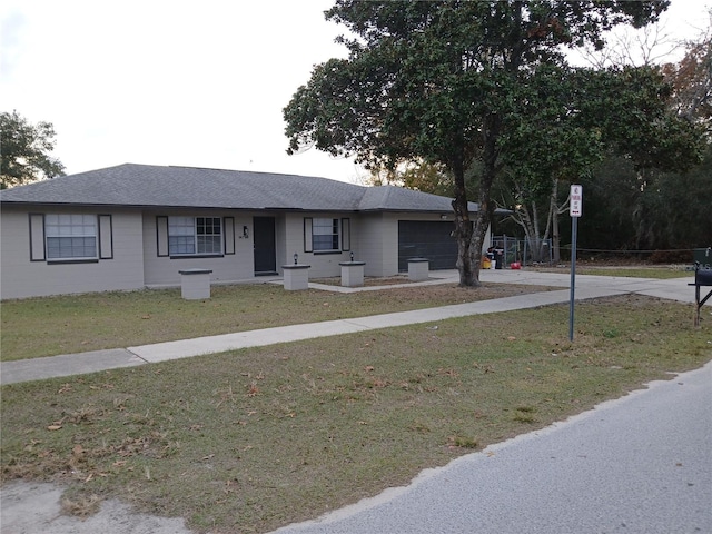 view of front of property with a front yard and a garage