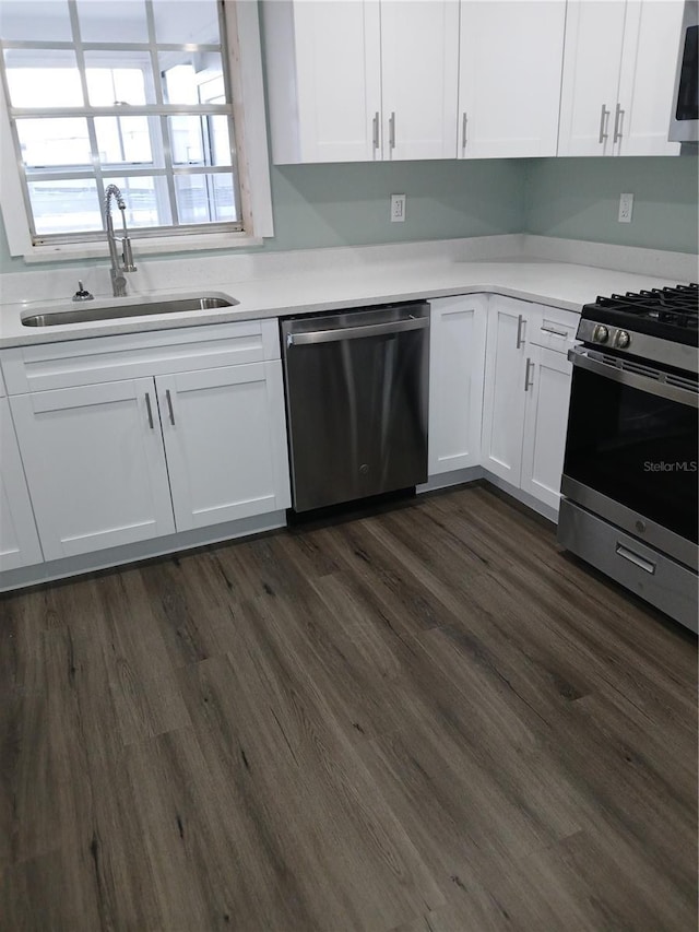 kitchen featuring white cabinets, dark hardwood / wood-style flooring, stainless steel appliances, and sink