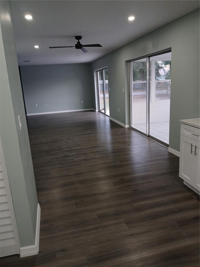 empty room with ceiling fan and dark hardwood / wood-style floors