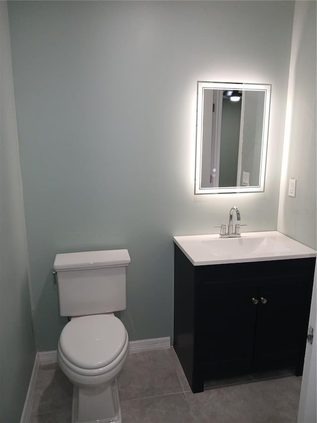 bathroom featuring tile patterned floors, vanity, and toilet