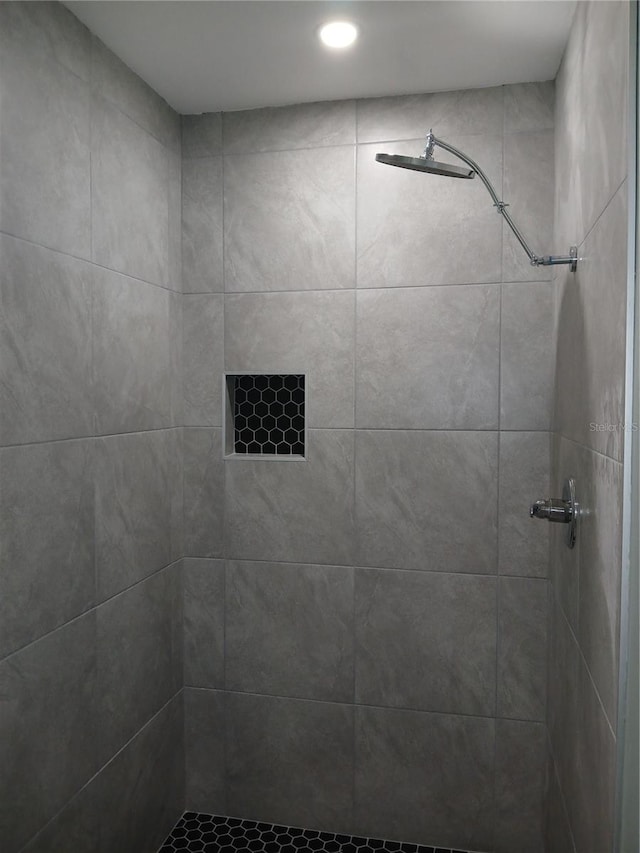 bathroom with a tile shower