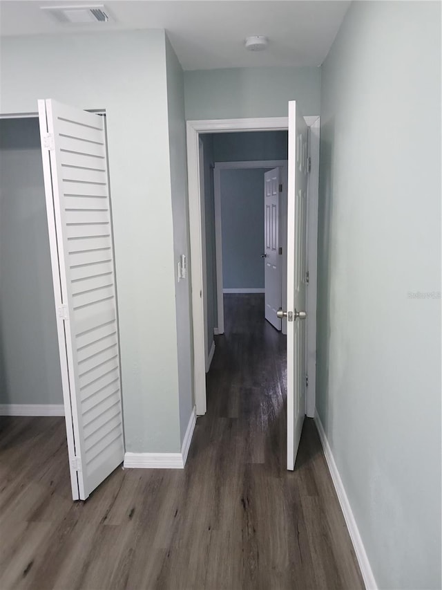 hallway featuring dark hardwood / wood-style flooring