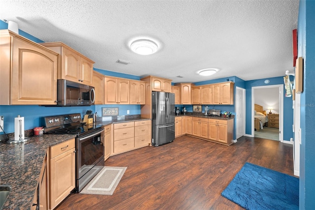 kitchen featuring dark hardwood / wood-style floors, dark stone countertops, a textured ceiling, light brown cabinetry, and appliances with stainless steel finishes