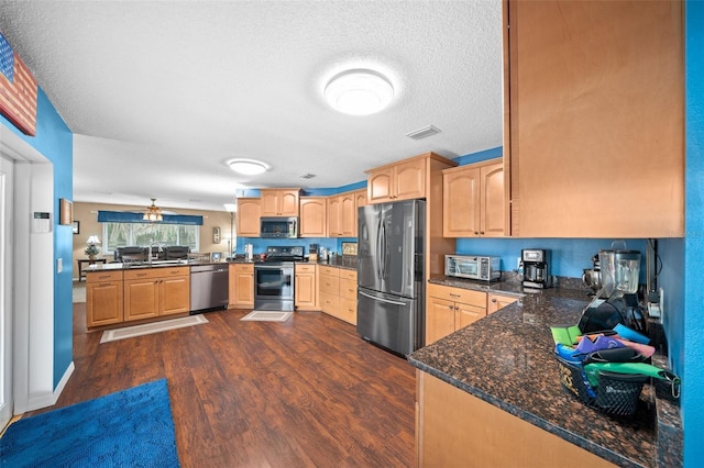 kitchen featuring kitchen peninsula, sink, stainless steel appliances, and a textured ceiling