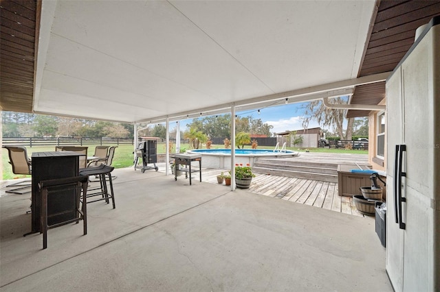 view of patio / terrace with a fenced in pool