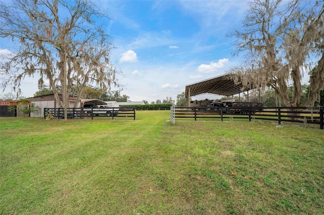 view of yard featuring a rural view and an outdoor structure