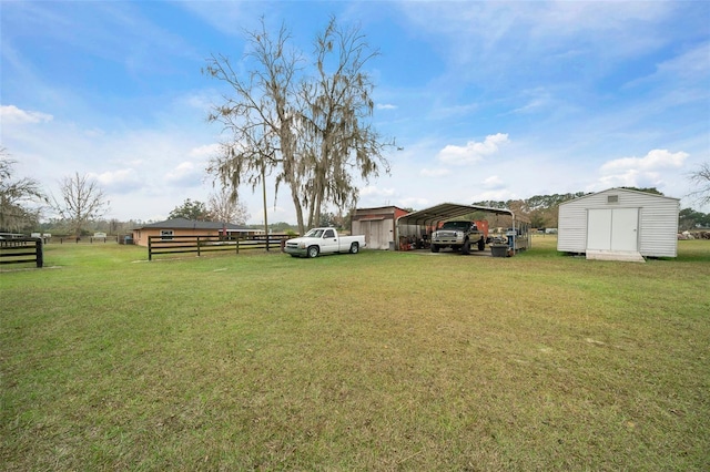 view of yard featuring a storage unit and a carport