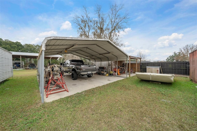 view of vehicle parking with a yard and a carport