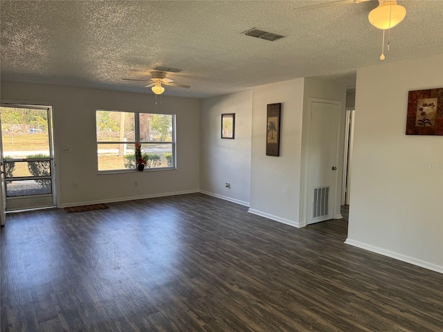 spare room with a textured ceiling, dark hardwood / wood-style flooring, and ceiling fan