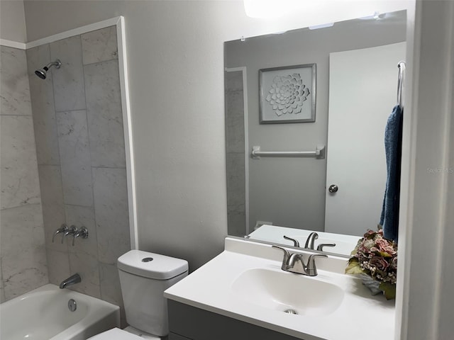 full bathroom featuring tiled shower / bath combo, toilet, and vanity