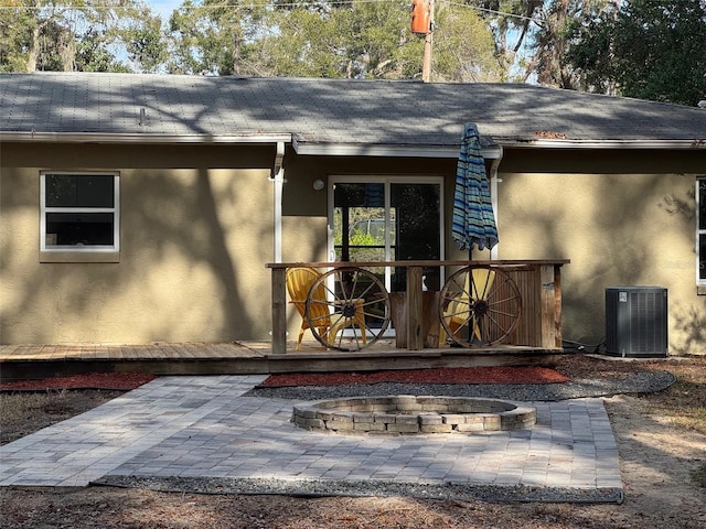 entrance to property featuring central air condition unit and a patio area