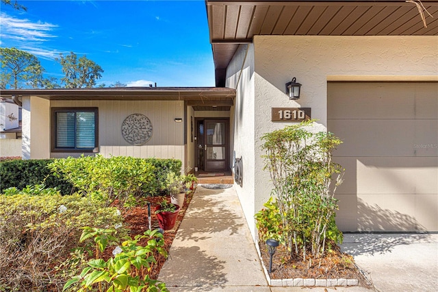 doorway to property with a garage