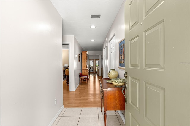 hall with light tile patterned floors