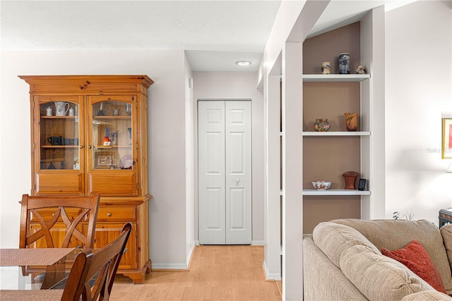 dining space featuring light hardwood / wood-style flooring and built in features