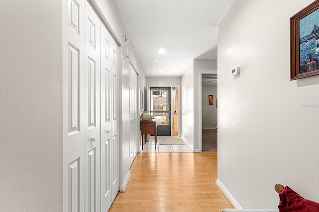 corridor featuring light wood-type flooring