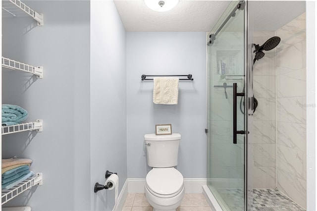 bathroom with toilet, a textured ceiling, tile patterned floors, and a shower with door