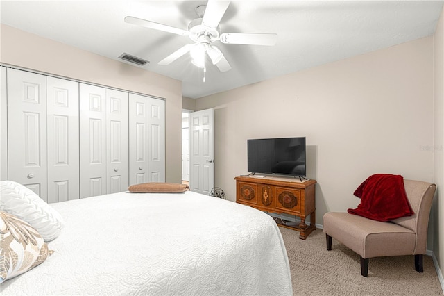 bedroom featuring ceiling fan, a closet, and light carpet