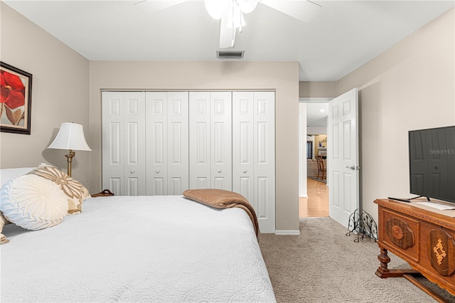 carpeted bedroom featuring a closet and ceiling fan