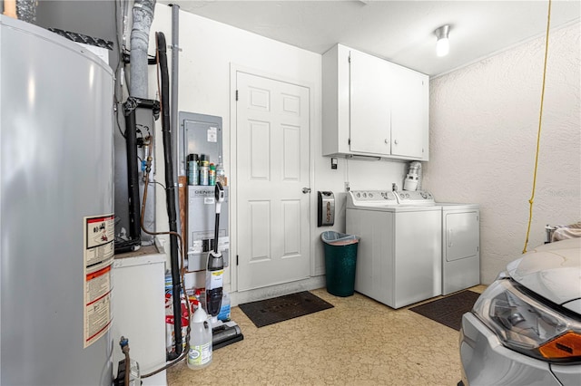 washroom featuring cabinets, washer and dryer, and gas water heater