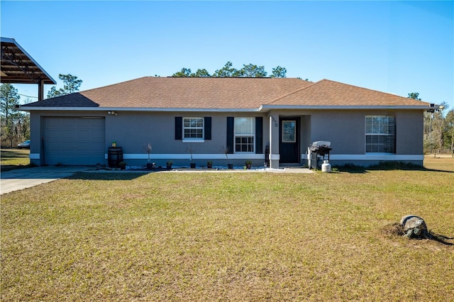 ranch-style house featuring a front lawn and a garage