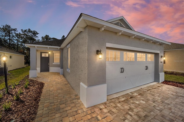 exterior space with a garage and central AC unit