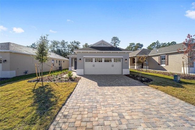 view of front facade with a garage and a front lawn