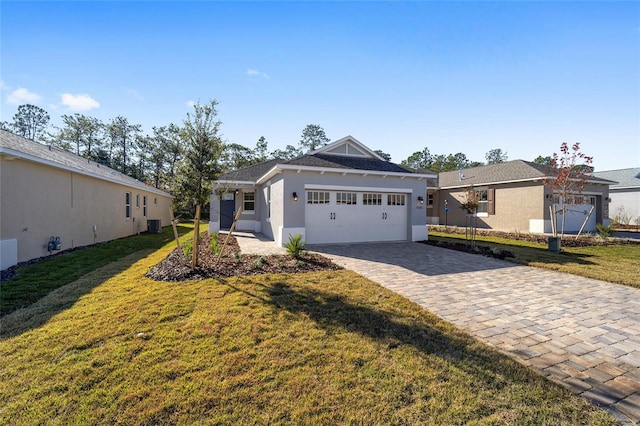 ranch-style home featuring a garage and a front yard