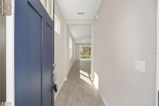 corridor with light wood-type flooring