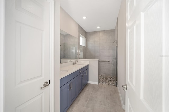 bathroom with vanity and a shower with door