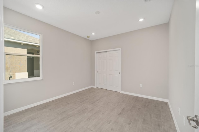 spare room featuring light hardwood / wood-style floors