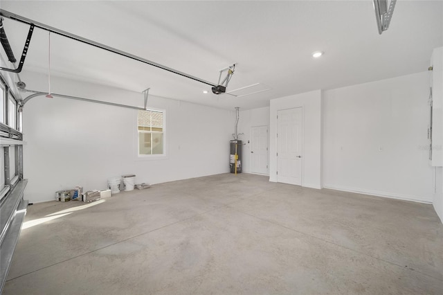 garage with a garage door opener and water heater