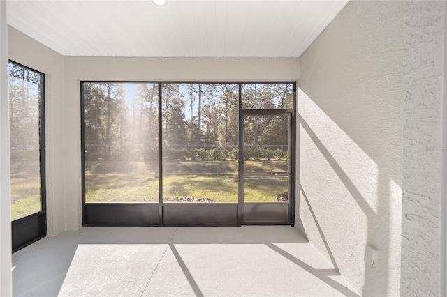 unfurnished sunroom featuring plenty of natural light