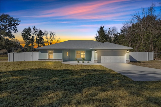 view of front of house with a yard and a garage