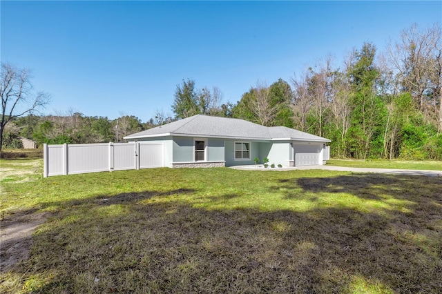 exterior space with a garage and a front lawn