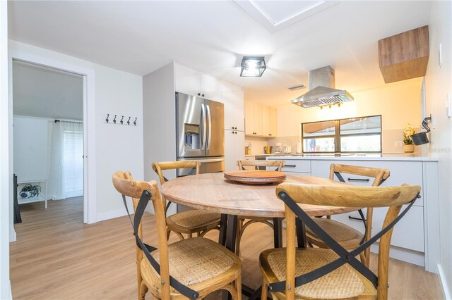 dining space with light wood-type flooring