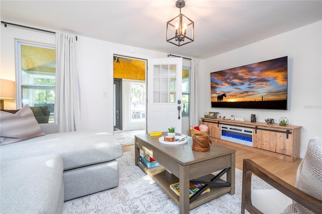 living room with hardwood / wood-style floors and a notable chandelier